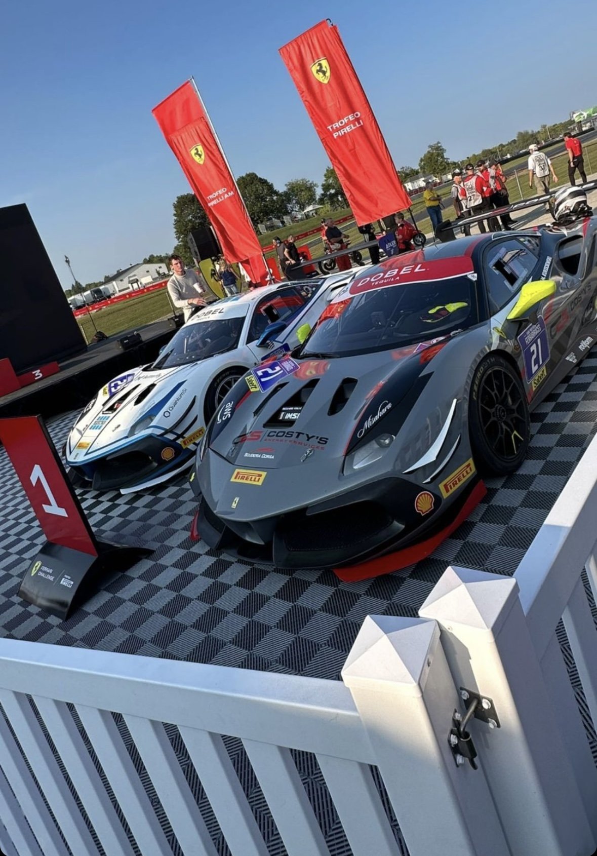 Ferrari race cars on checkerboard event flooring at a brand activation